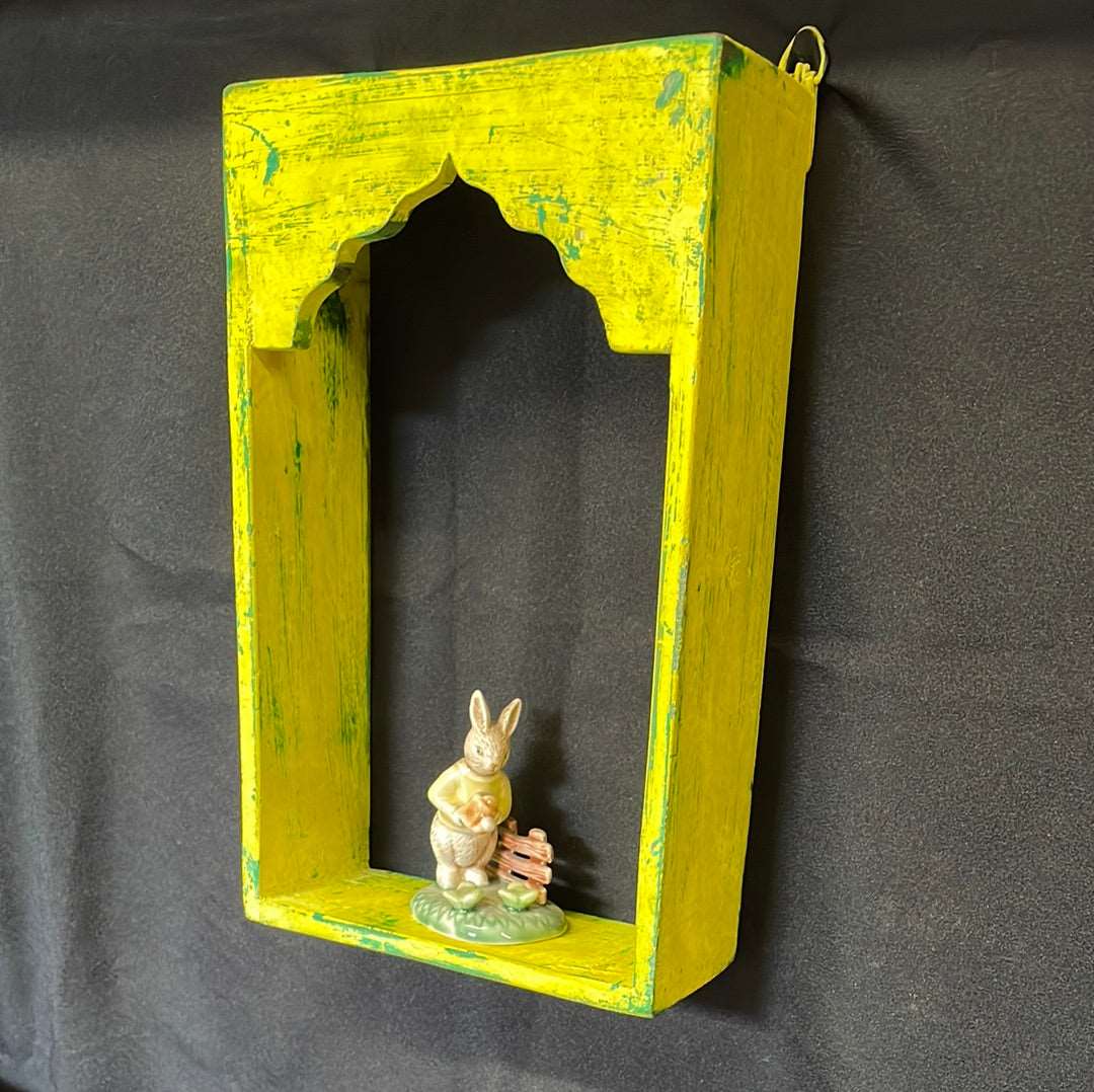 Single Indian wooden temple arch shelf yellow distressed finish.