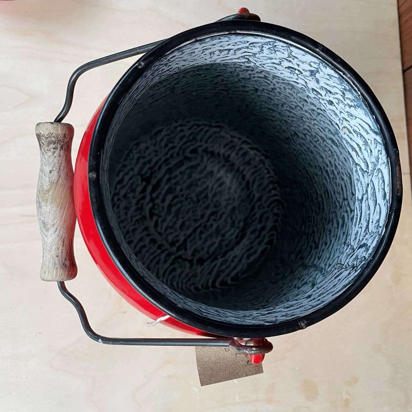 Red enamelled churn container with lid.
