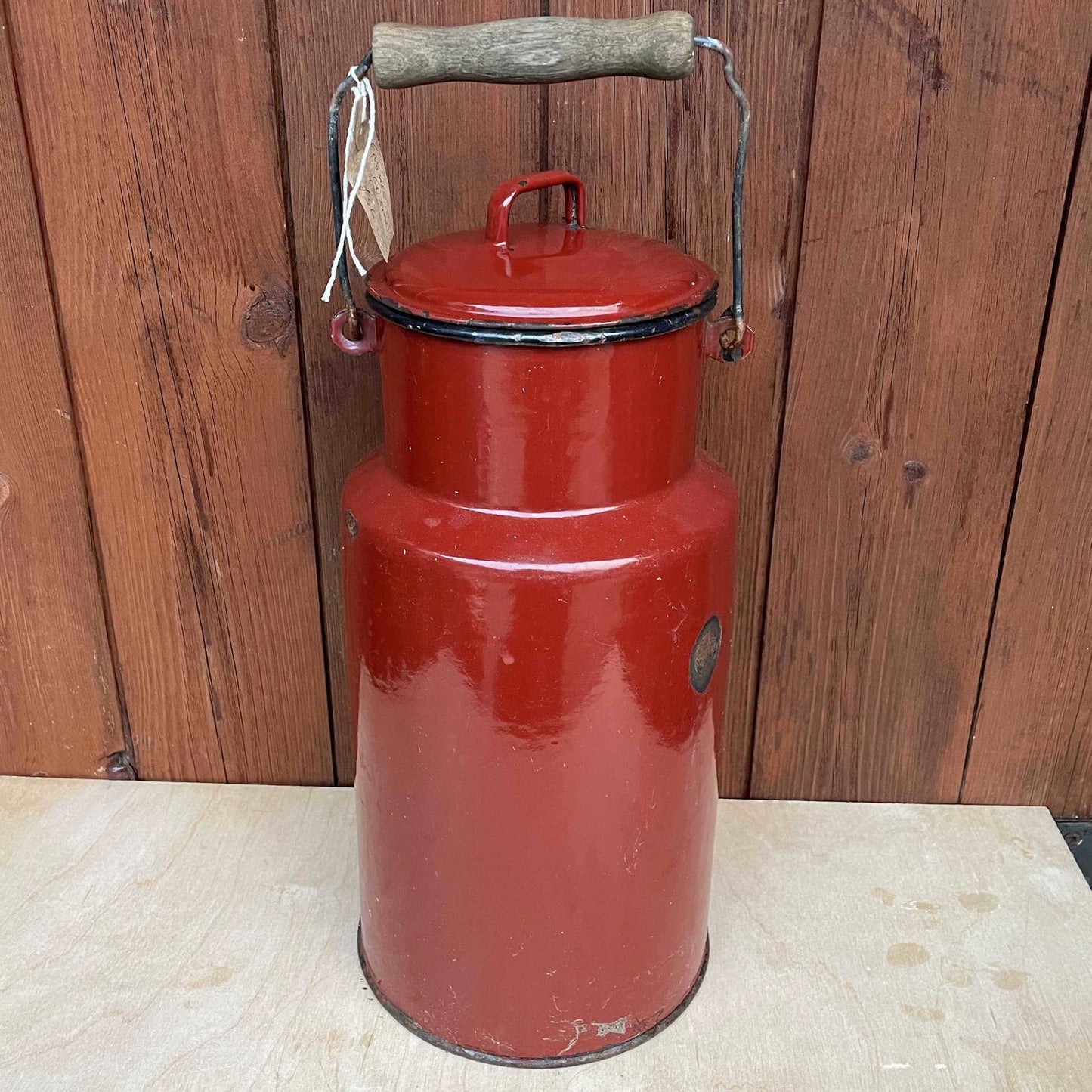 Brown enamelled churn container with lid.