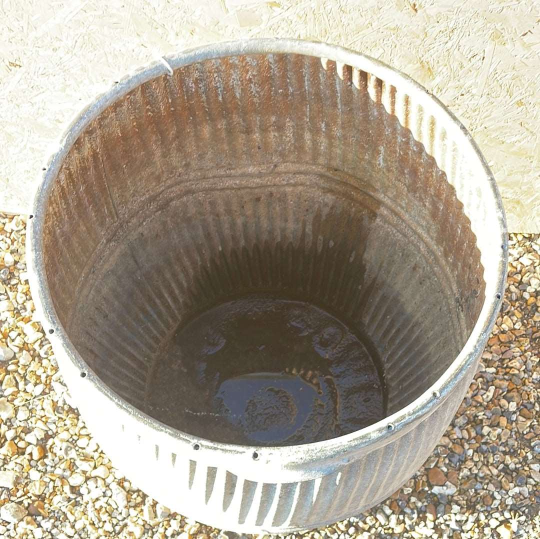 Vintage dolly tub planter ribbed with side handles.