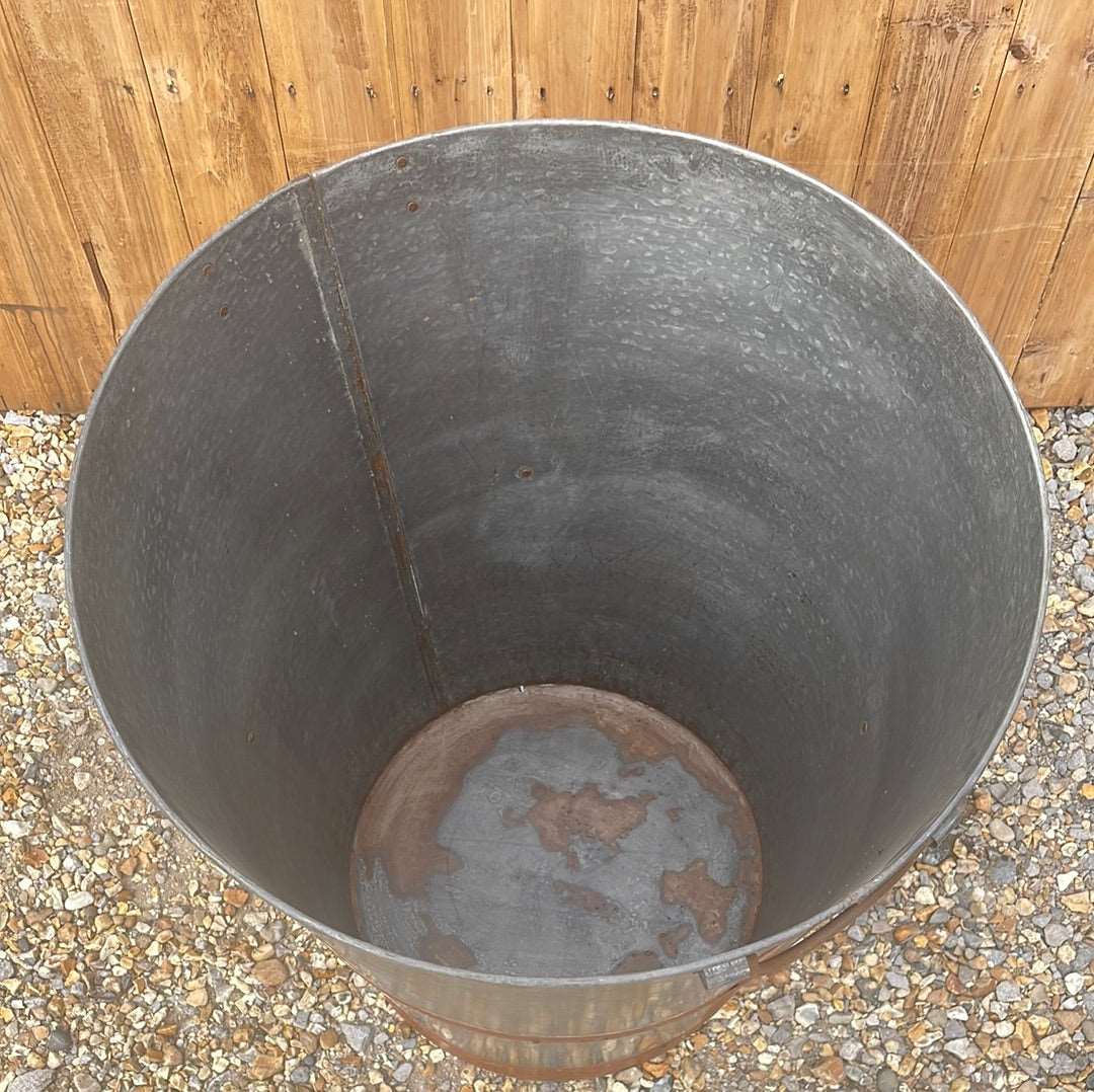 Large bucket type metal planter tree planting pot.