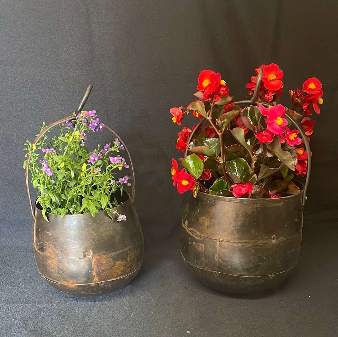 Indian metal hanging pot planter two sizes containing flowers.