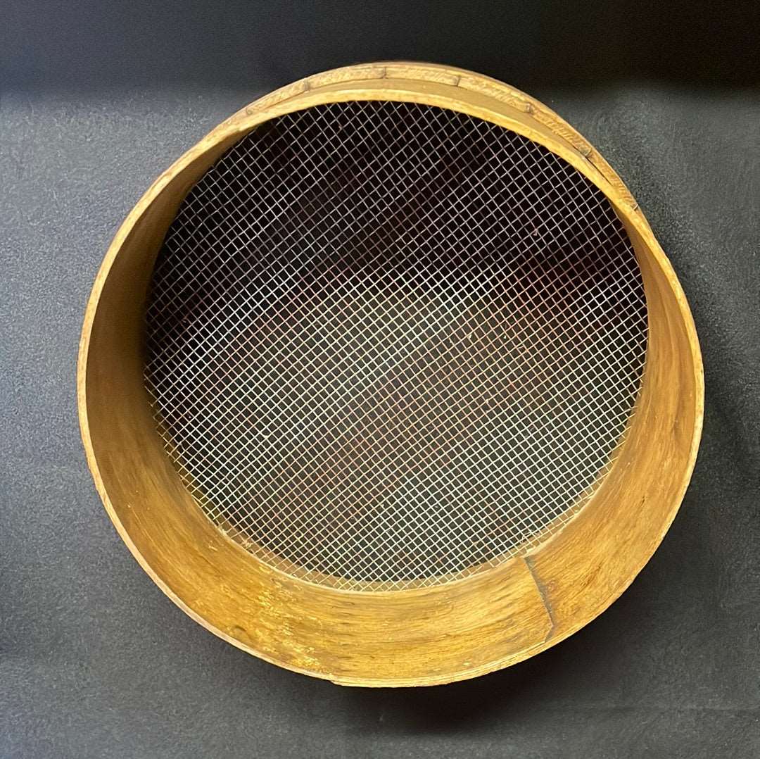 Vintage wooden sided grain sieve.