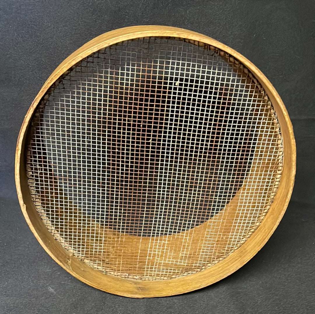 Vintage wooden sided grain sieve.