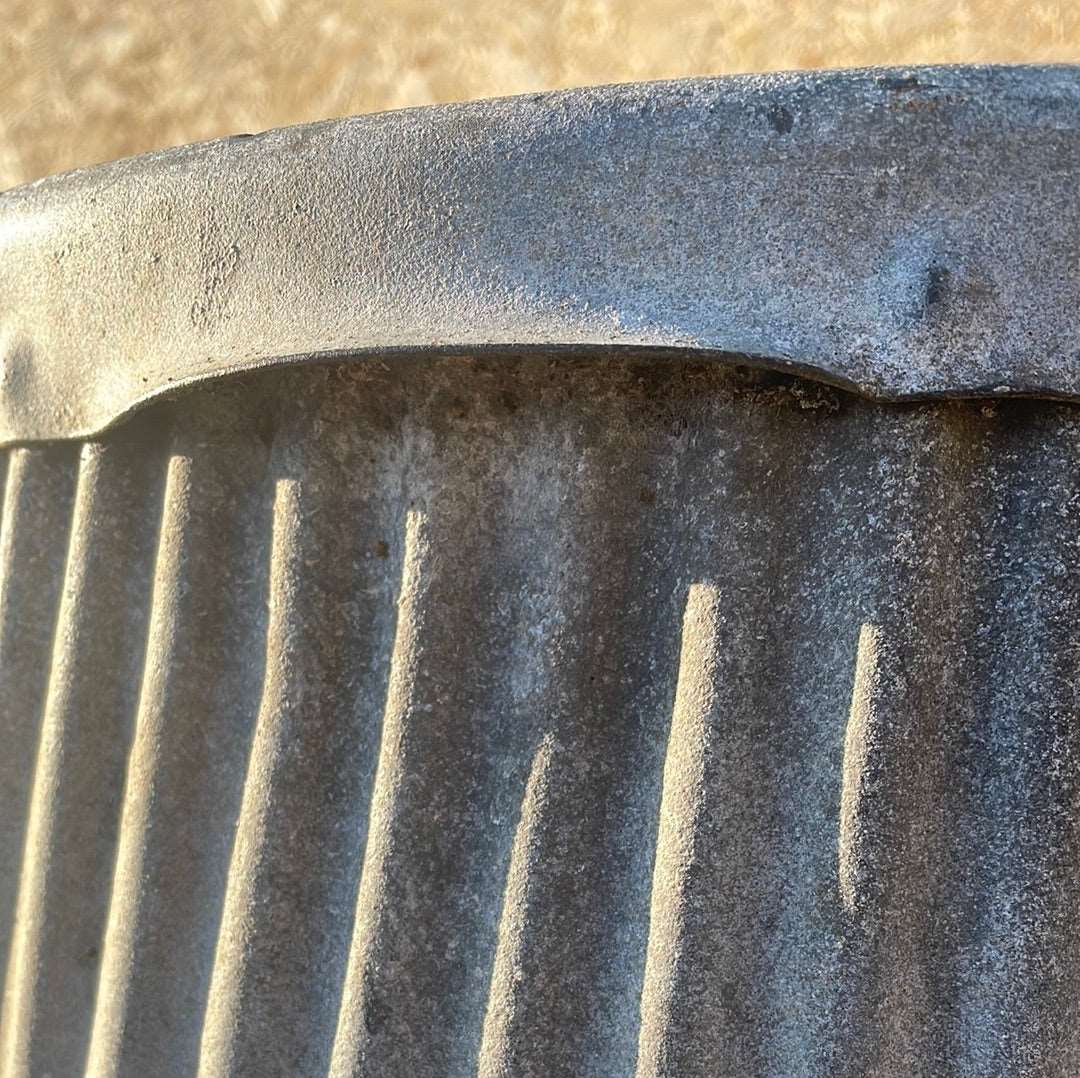 Vintage dolly tub planter ribbed with side handles.