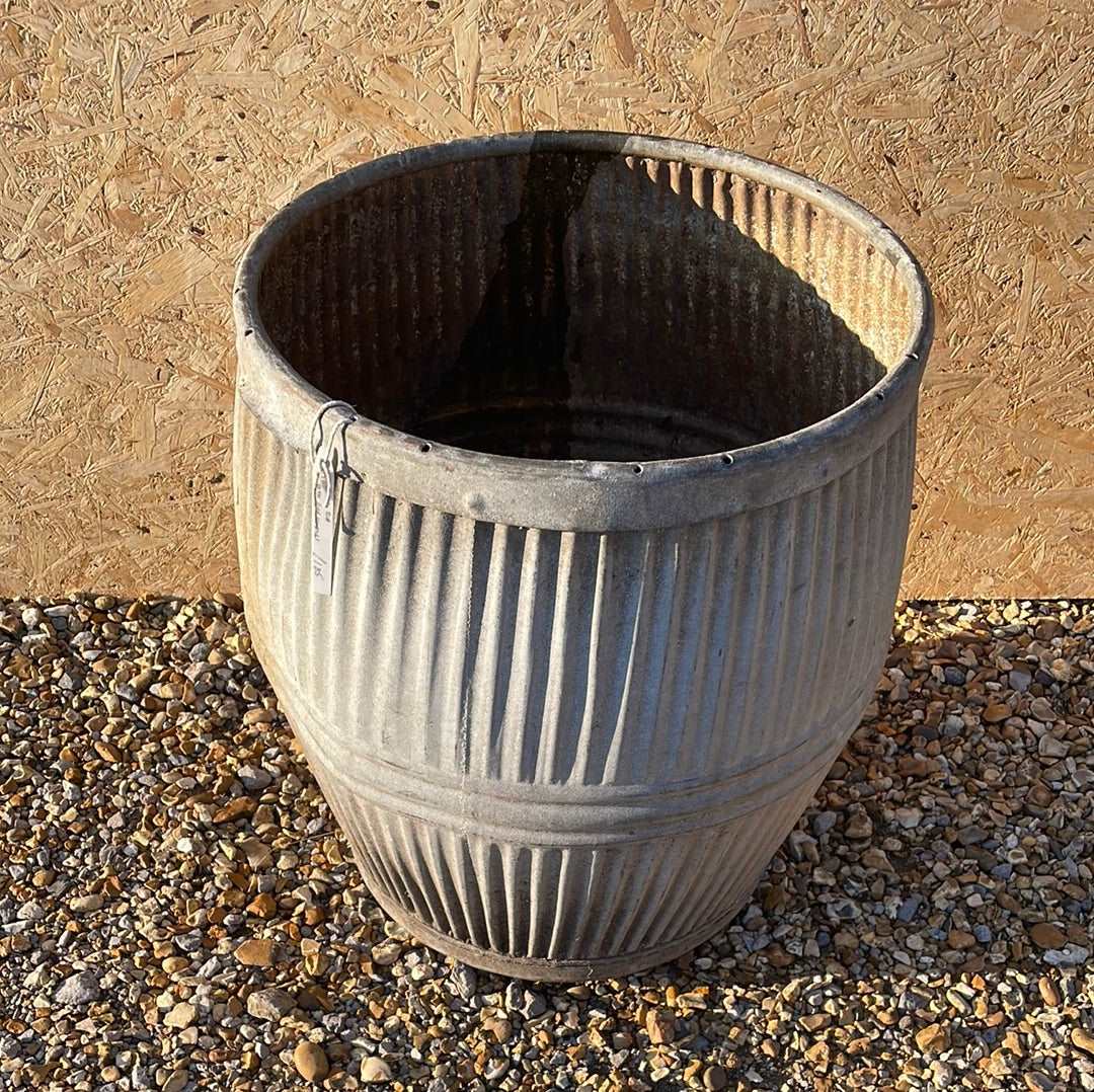 Vintage dolly tub planter ribbed with side handles.