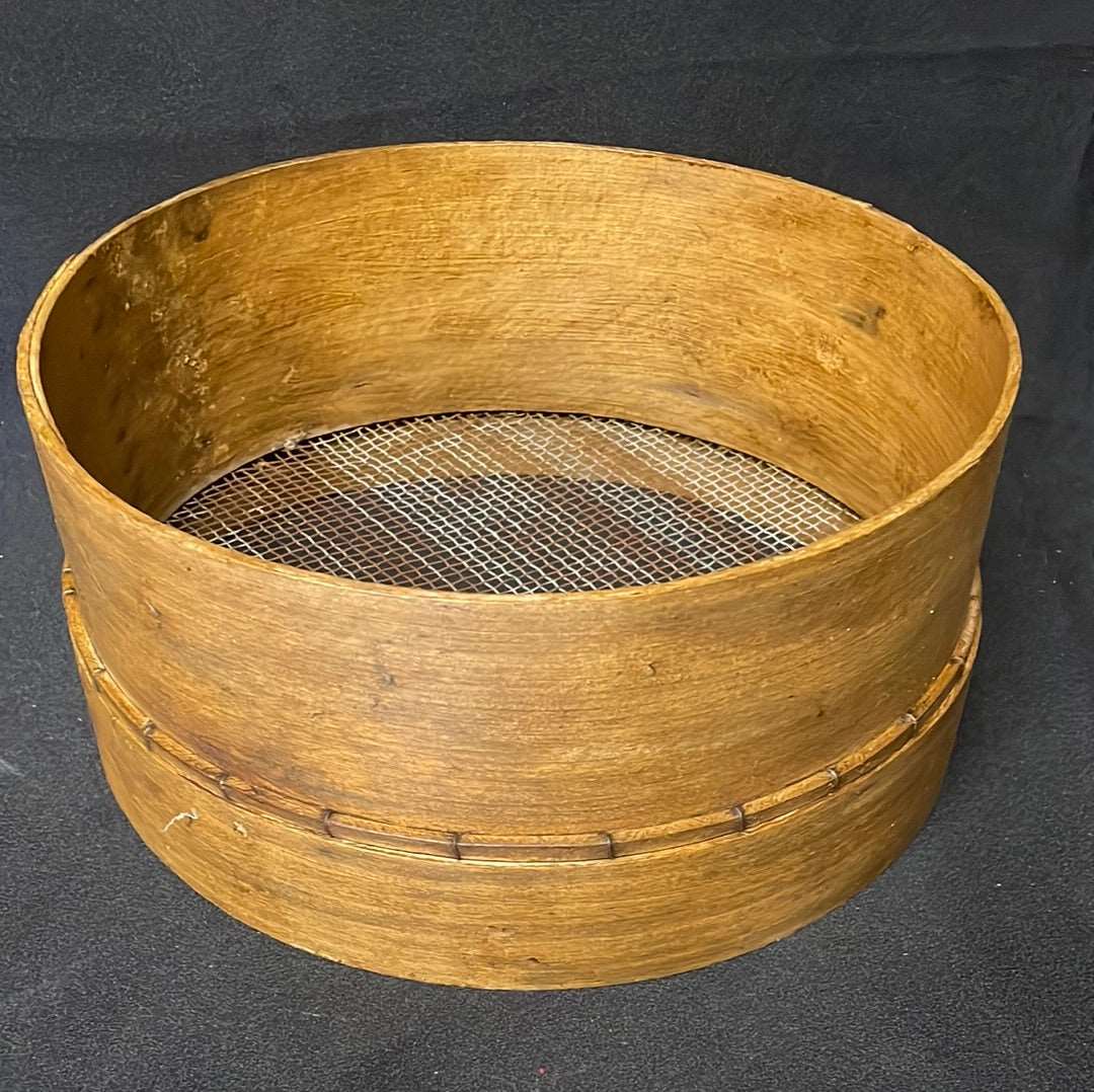 Vintage wooden sided grain sieve.