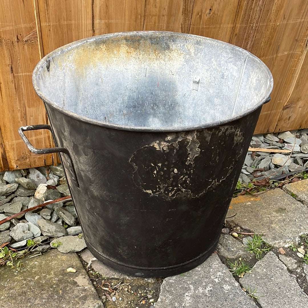 Tapered sided rustic galvanised two handled bin garden planter aged black paint.