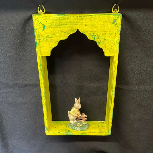 Single Indian wooden temple arch shelf yellow distressed finish.