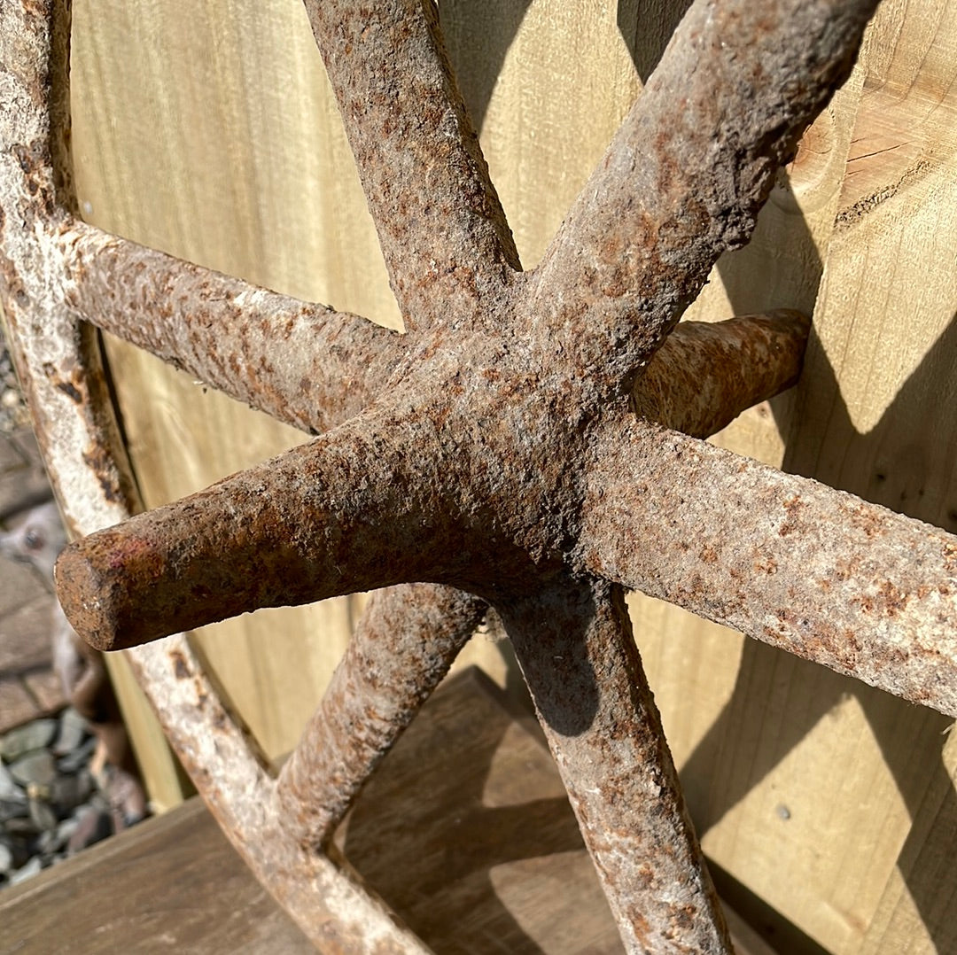 Antique cast iron barrow wheel rustic garden decor.