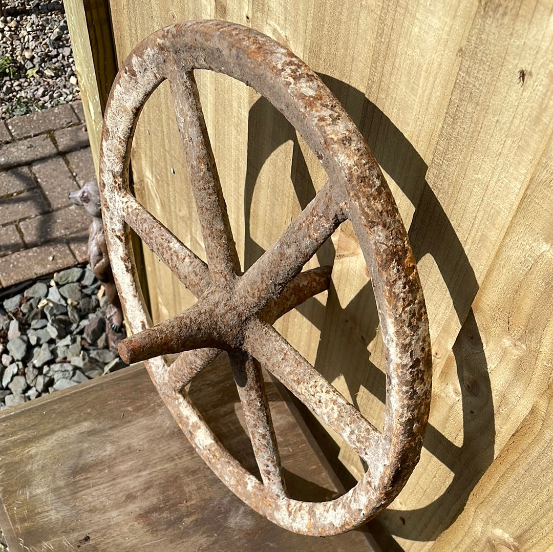 Antique cast iron barrow wheel rustic garden decor.