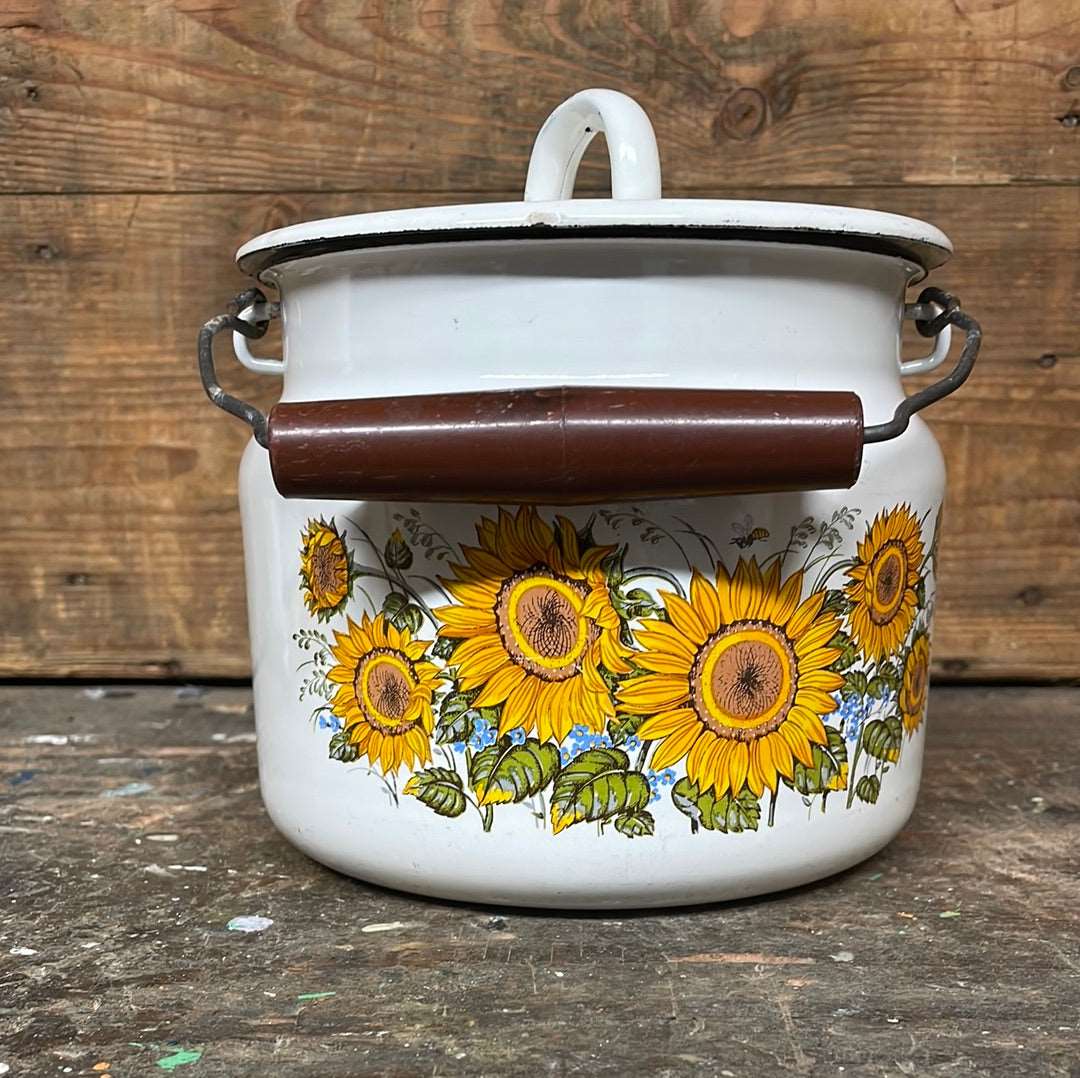 White enamel pot with handle and lid, sunflower décor.