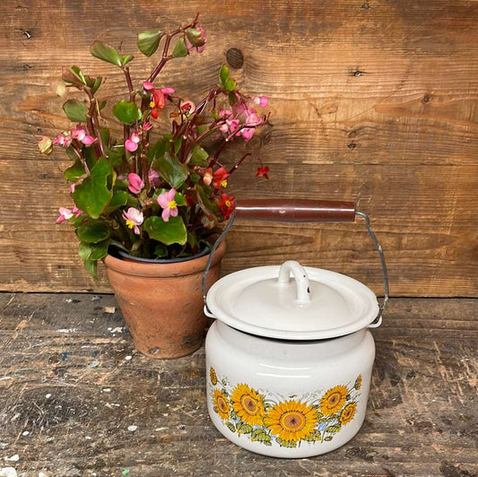 White enamel pot with handle and lid, sunflower décor.