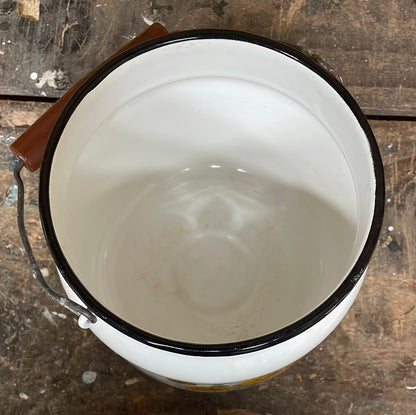 White enamel pot with handle and lid, sunflower décor.