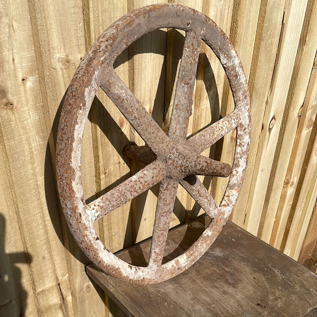 Antique cast iron barrow wheel rustic garden decor.