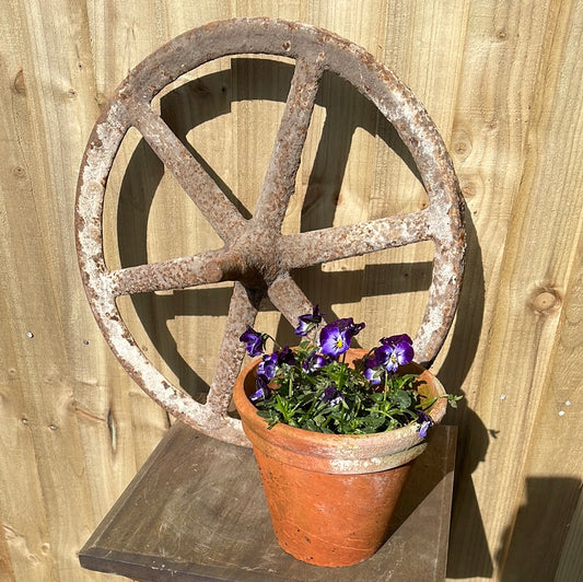 Antique cast iron barrow wheel rustic garden decor.
