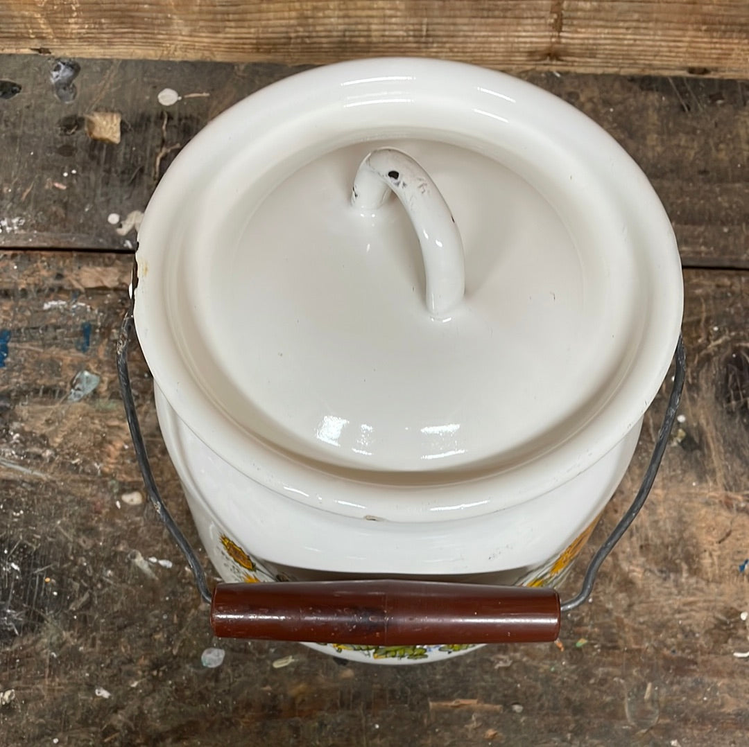 White enamel pot with handle and lid, sunflower décor.