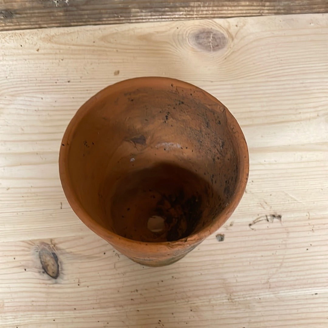 Vintage small terracotta plant flower seedling pot.