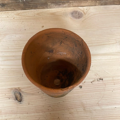 Vintage small terracotta plant flower seedling pot.