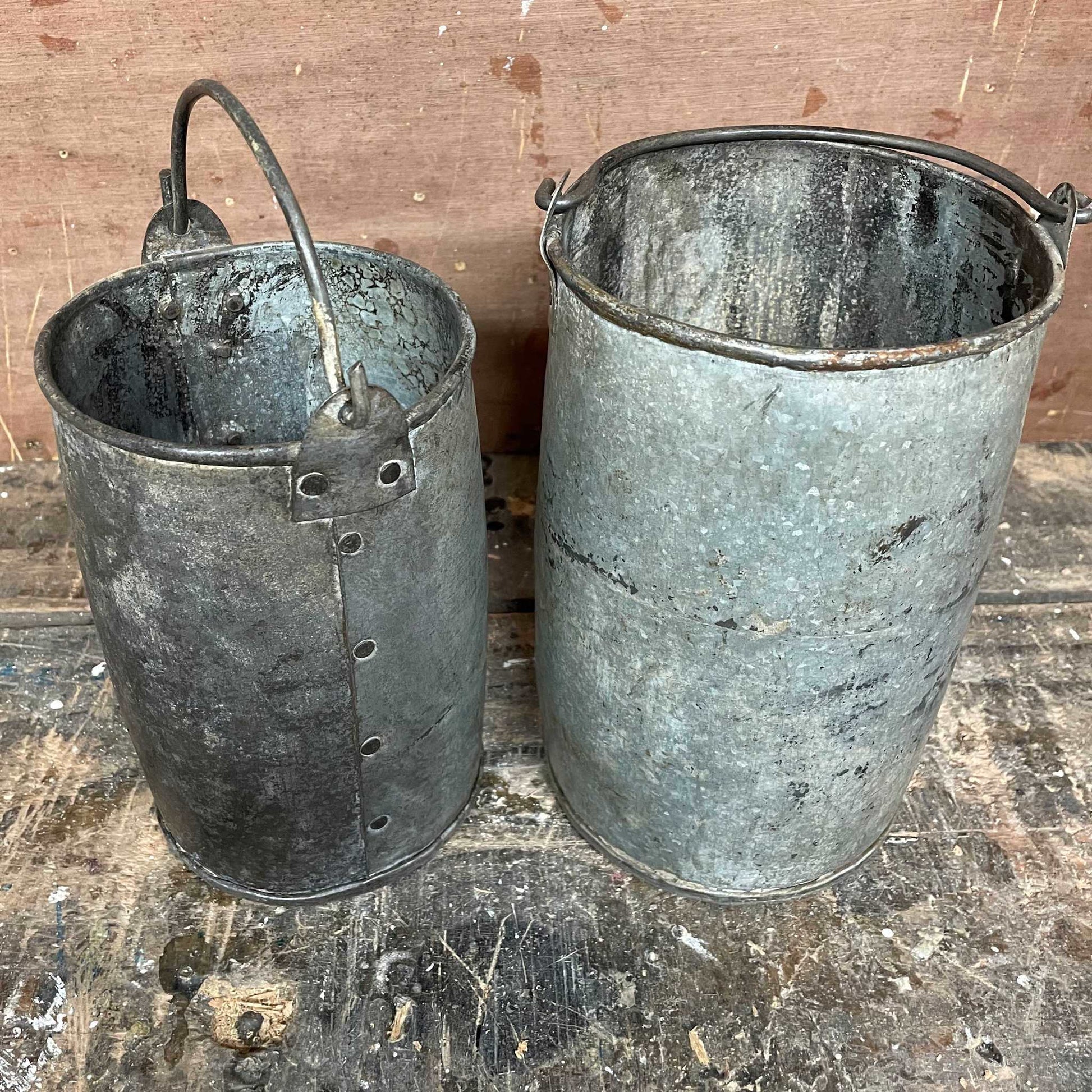 Metal planter bucket with handle.