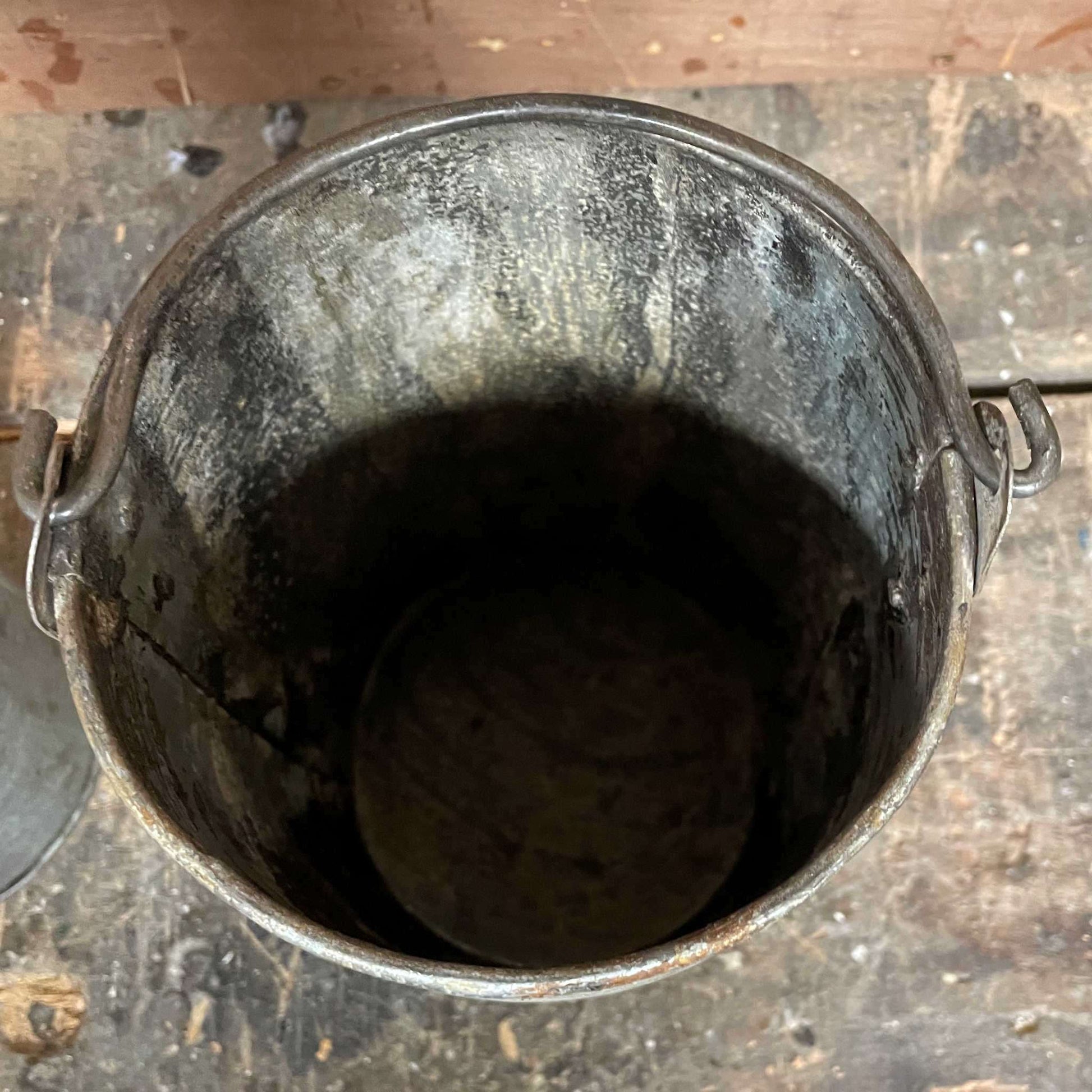 Metal planter bucket with handle.