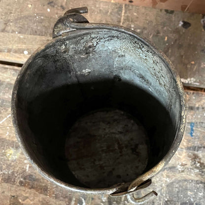 Metal planter bucket with handle.
