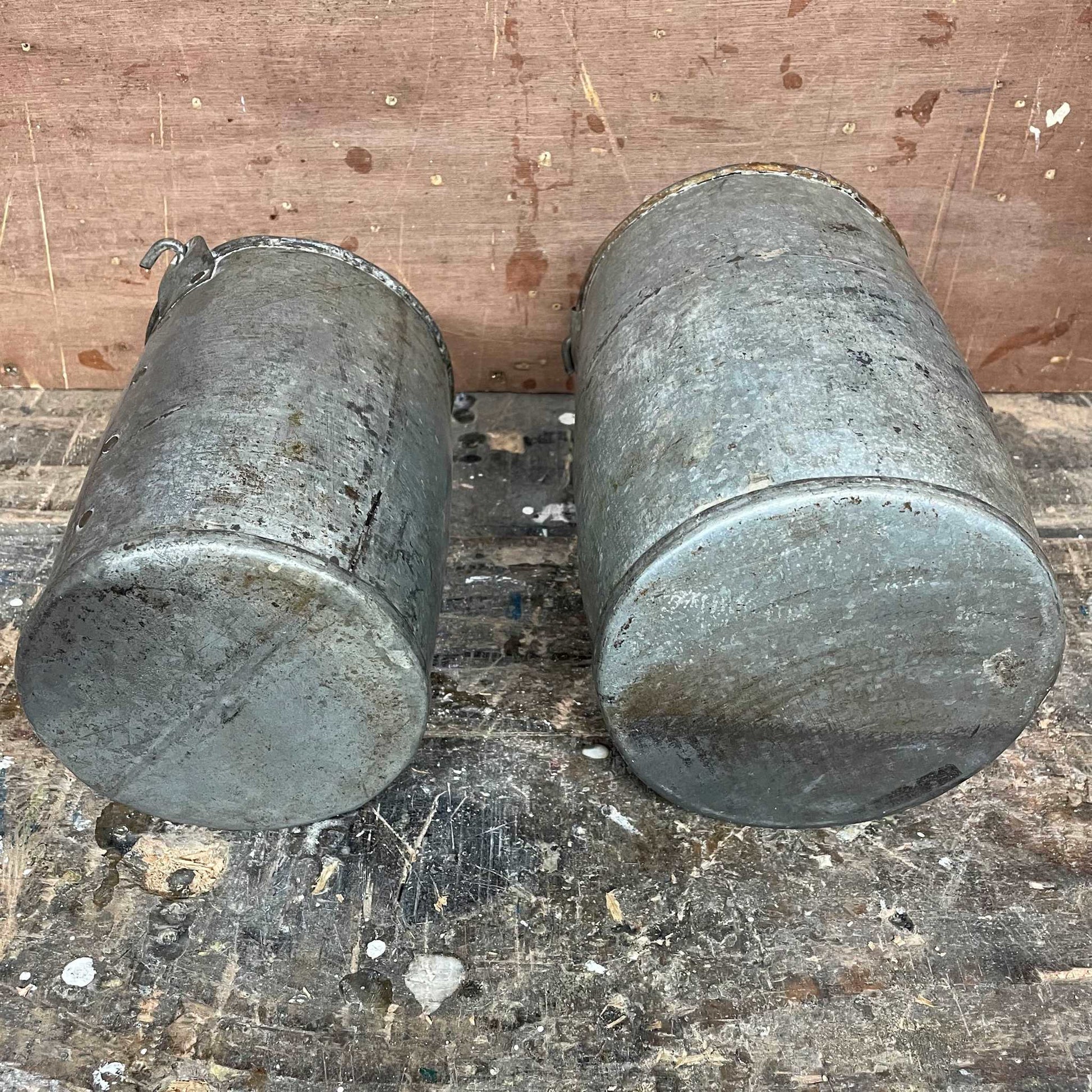 Metal planter bucket with handle.