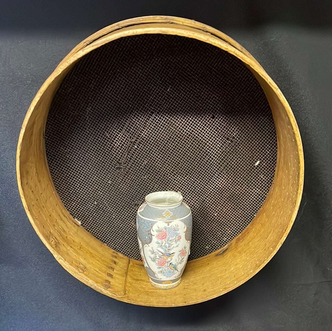 Vintage wooden sided grain sieve.