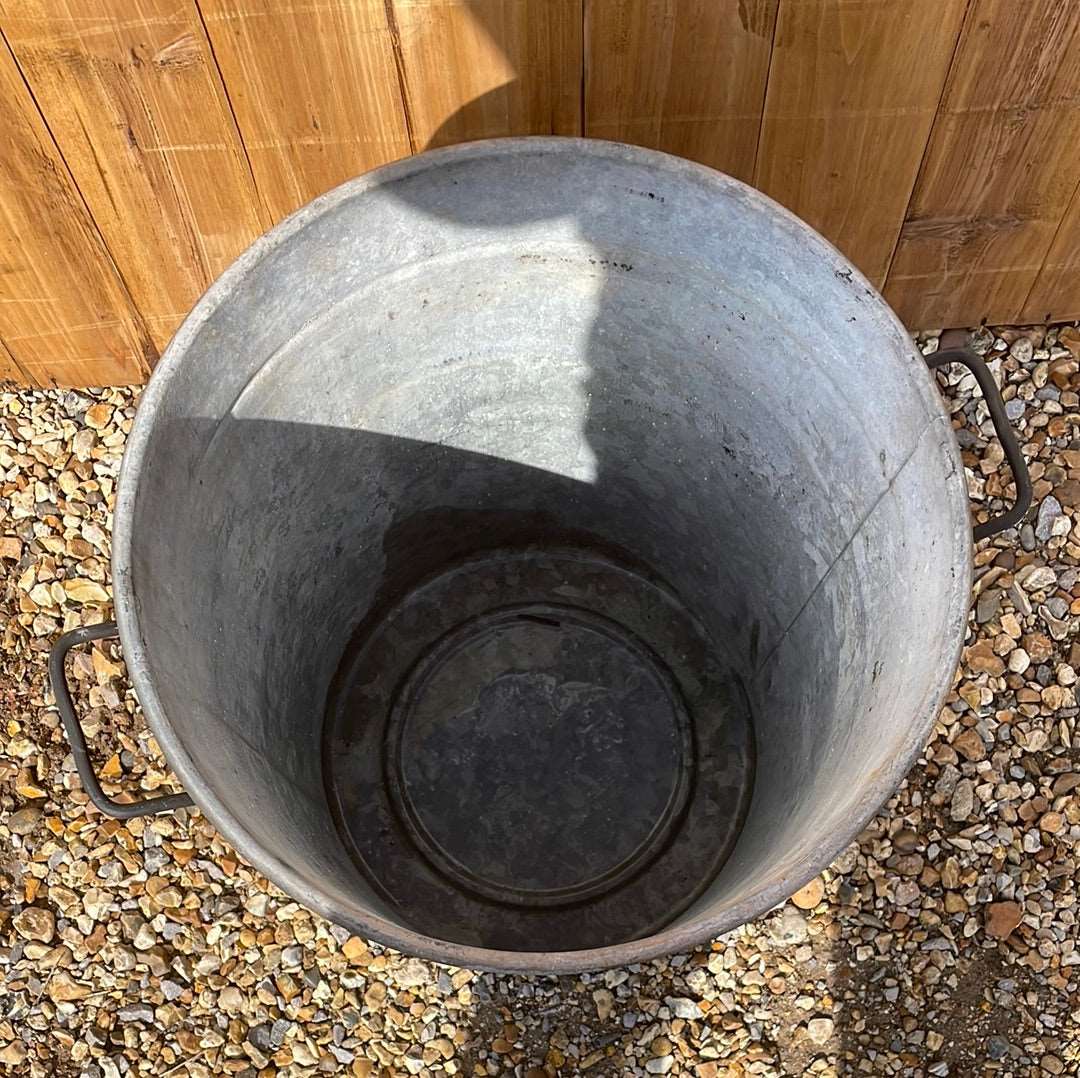 Rustic round galvanised bin garden planter with black aged paint.