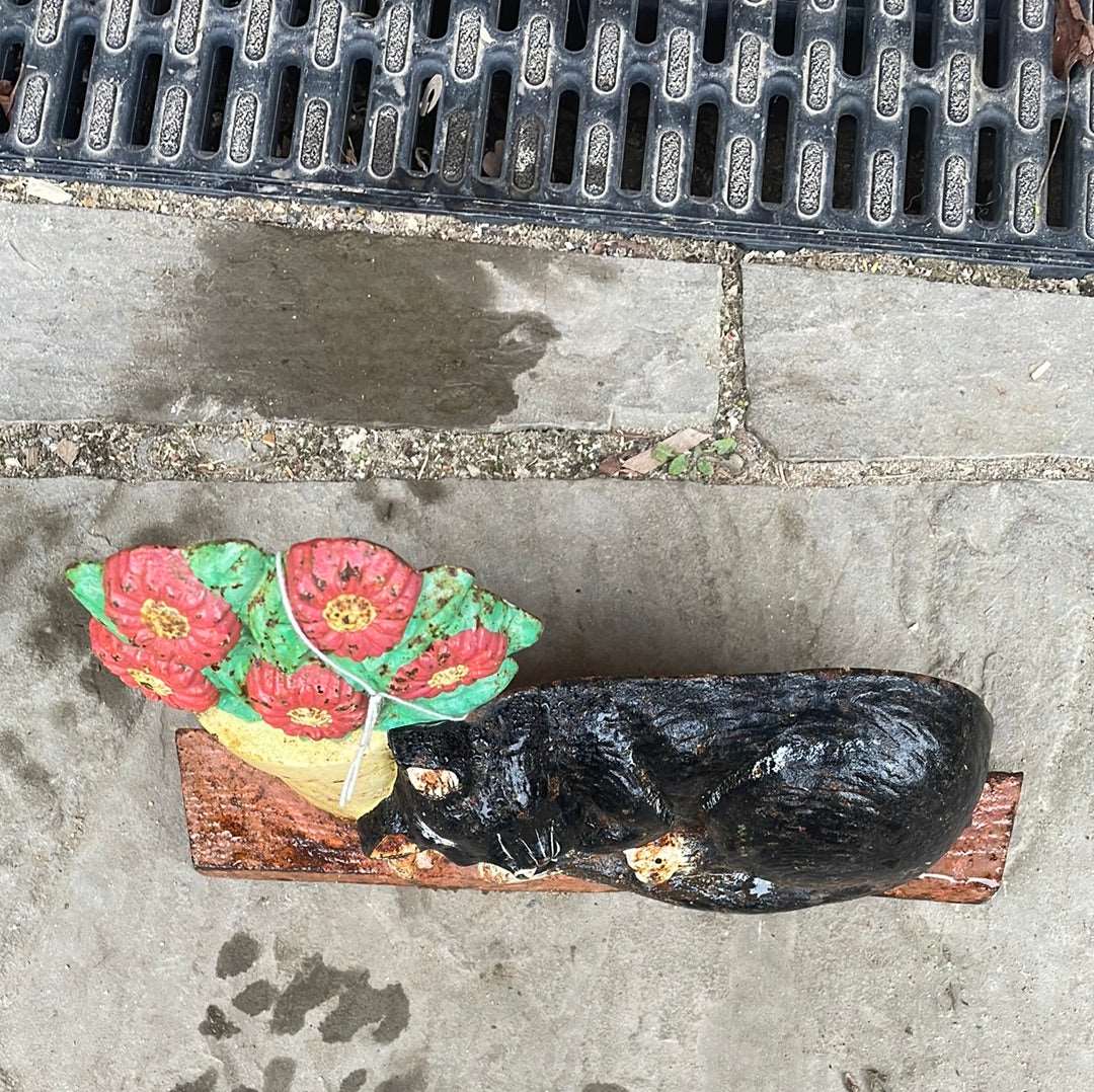 Cast iron cat and flower pot door stop.