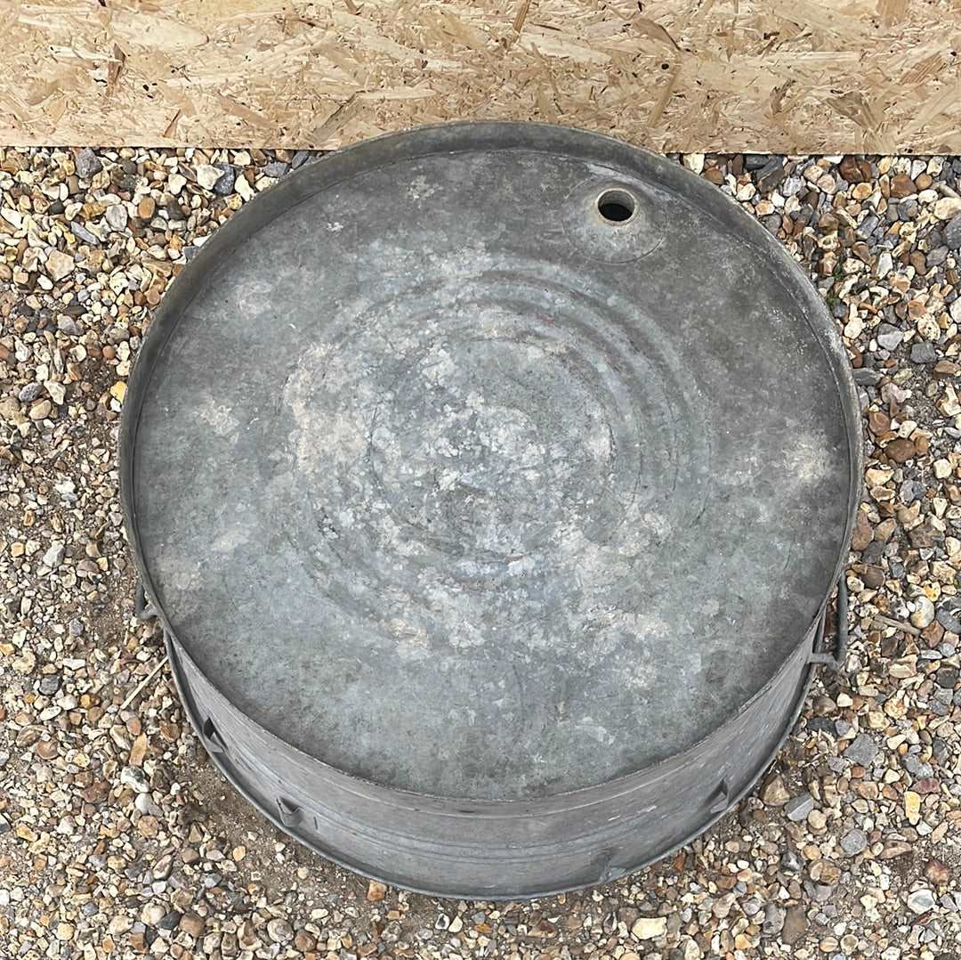 Round shallow galvanised straight sided tub planter with two handles.