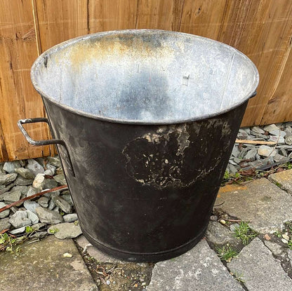 Tapered sided rustic galvanised two handled bin garden planter aged black paint.