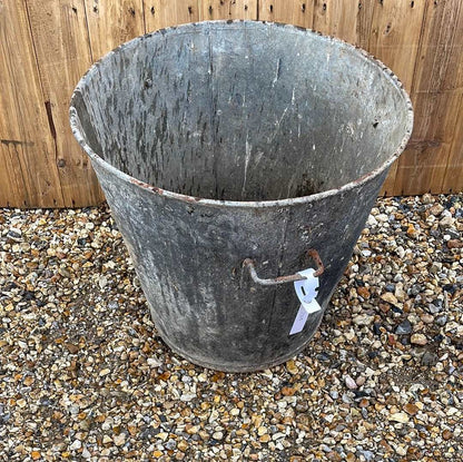 Taper sided two handled rustic galvanised bin garden planter container.